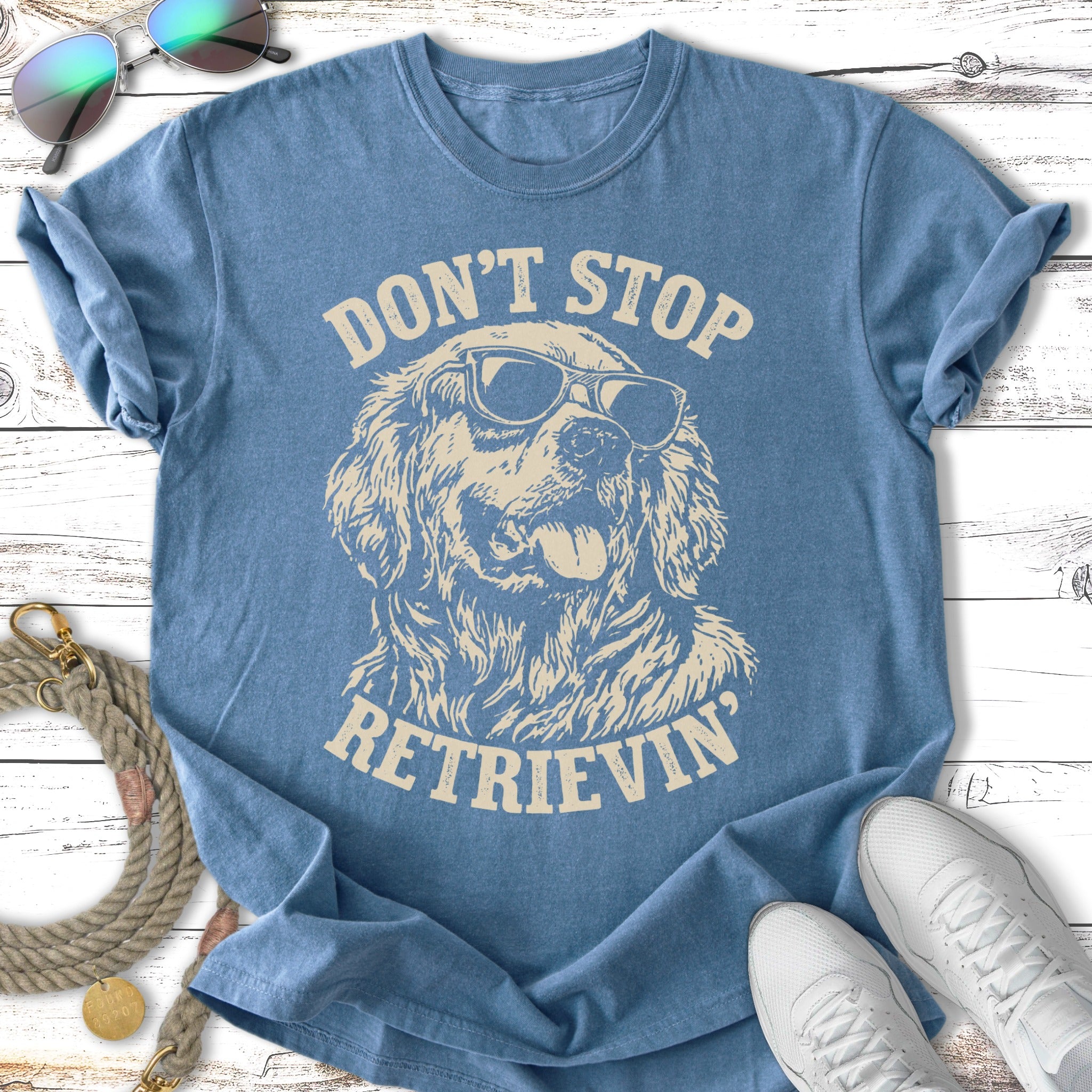 Blue t-shirt with vintage distressed Golden Retriever wearing sunglasses and text "Don't Stop Retrieving".