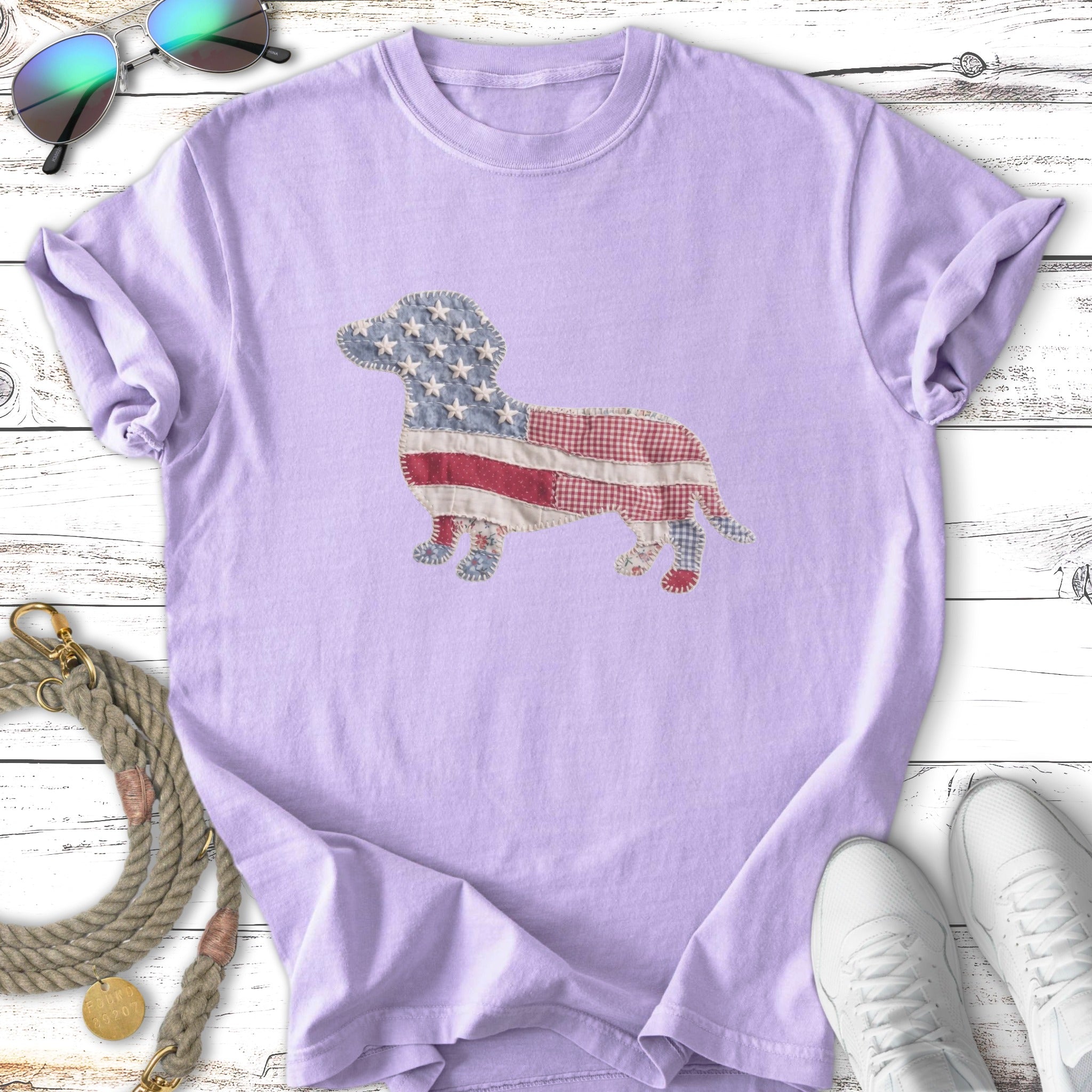 Purple t-shirt with a dachshund silhouette made of American flag fabric.