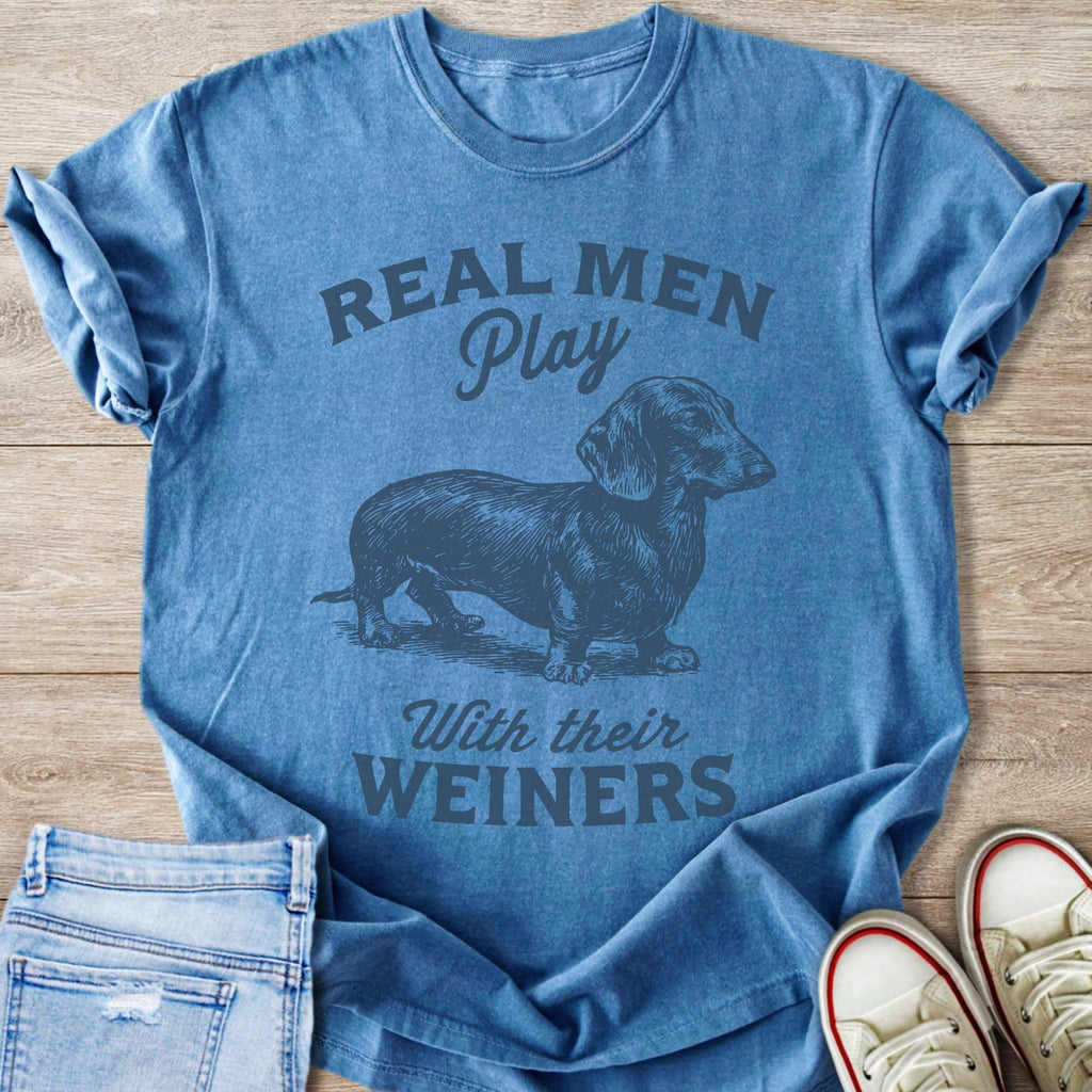 Blue t-shirt with "Real Men Play With Their Weiners" text and dachshund graphic.
