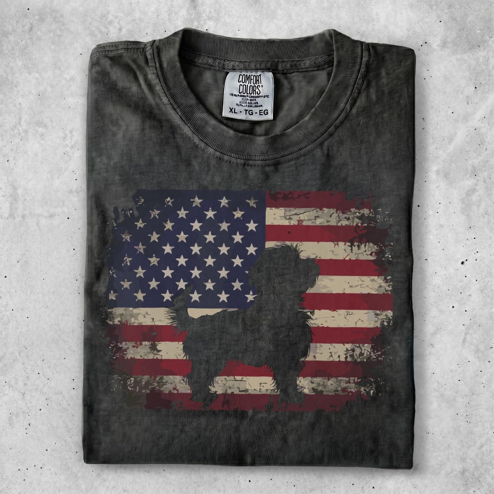 Black poodle silhouette superimposed on a distressed American flag on a t-shirt.