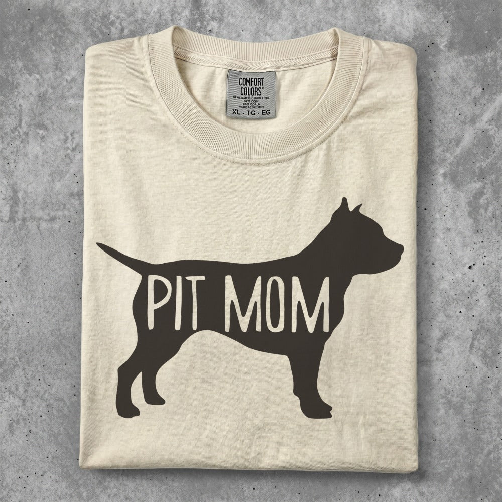 Cream t-shirt with "PIT MOM" text in black silhouette.