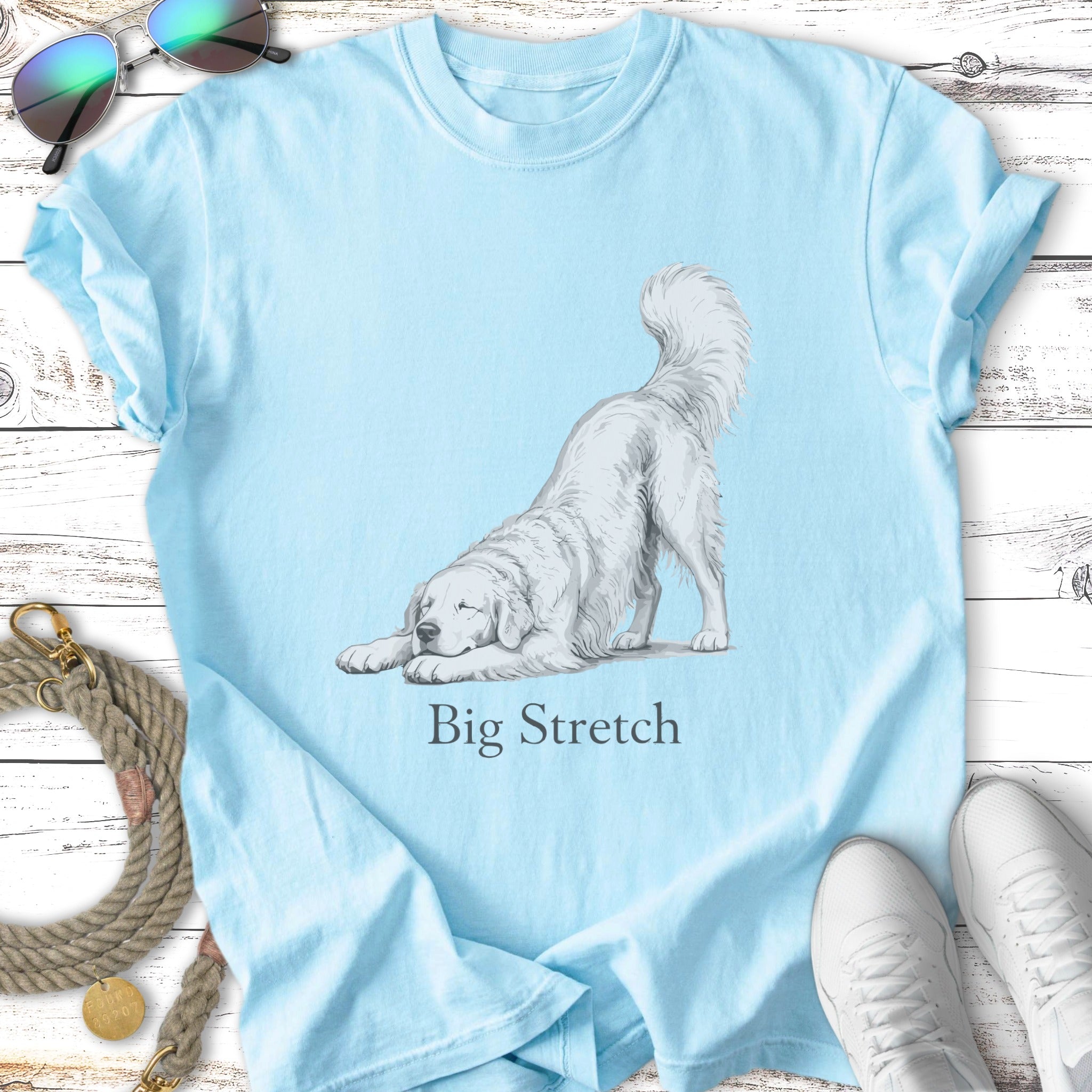 Light blue t-shirt with a drawing of a white dog stretching.