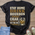 Black t-shirt with graphic text: Stay Home Drink Bourbon Smoke Cigar And Pet the Dog