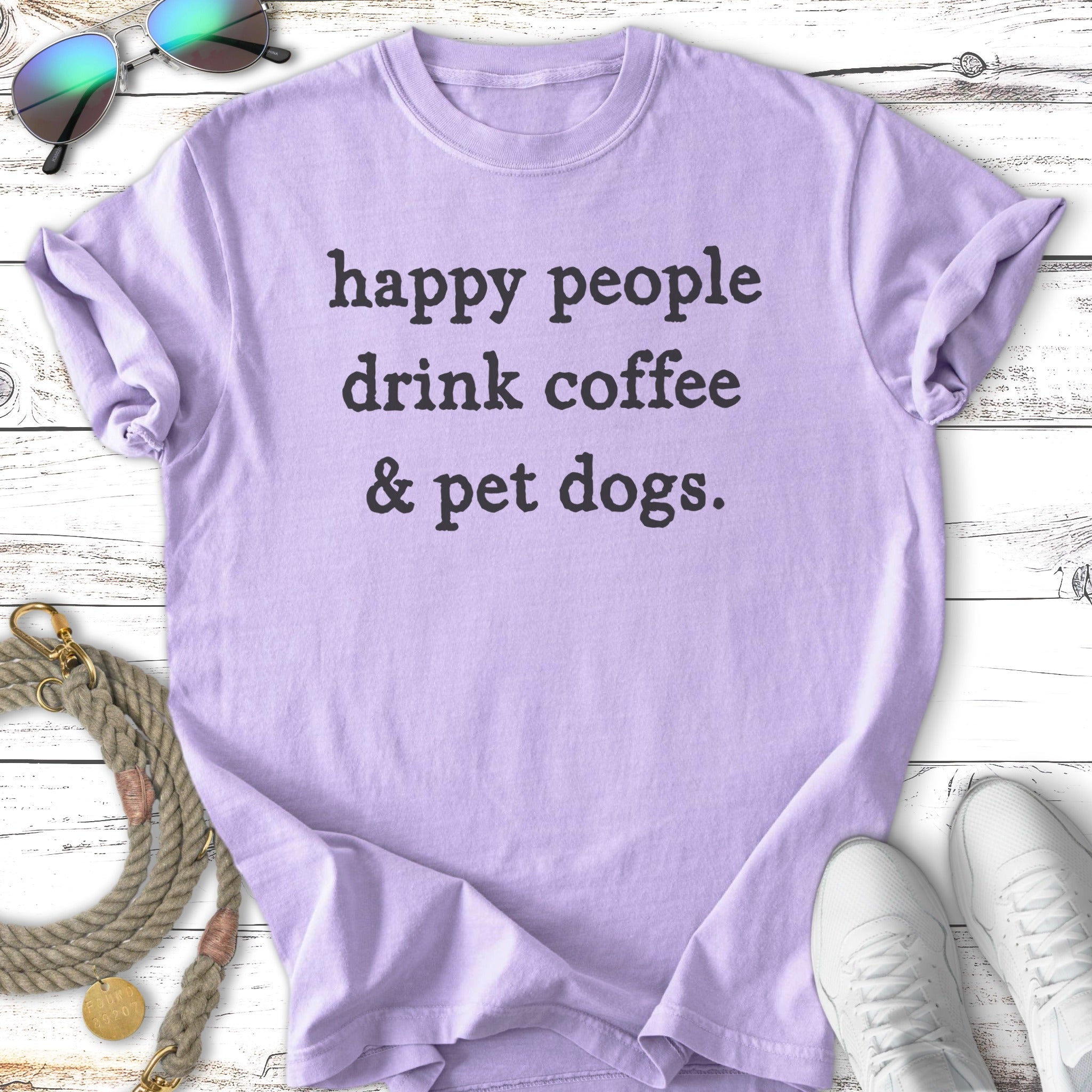Lavender t-shirt with "happy people drink coffee & pet dogs." text.
