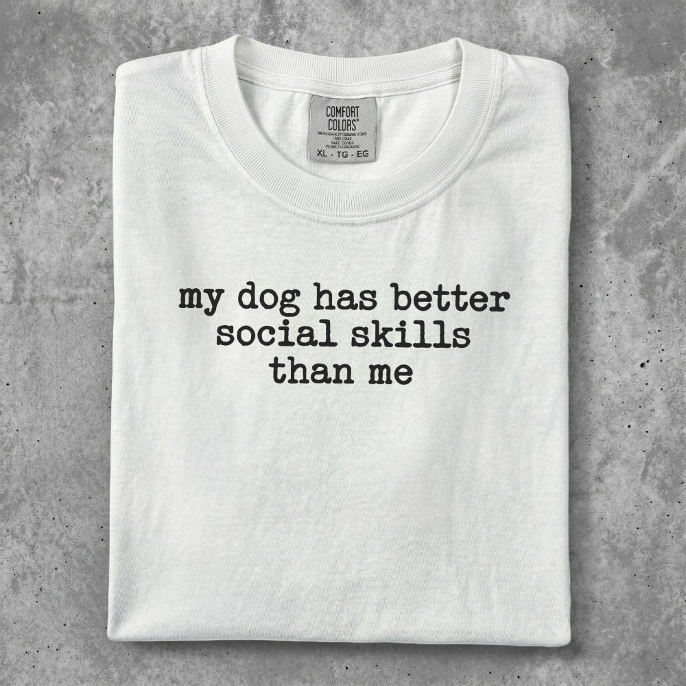 White t-shirt with "my dog has better social skills than me" text.