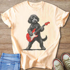 Black poodle with sunglasses playing a red electric guitar on a peach t-shirt.
