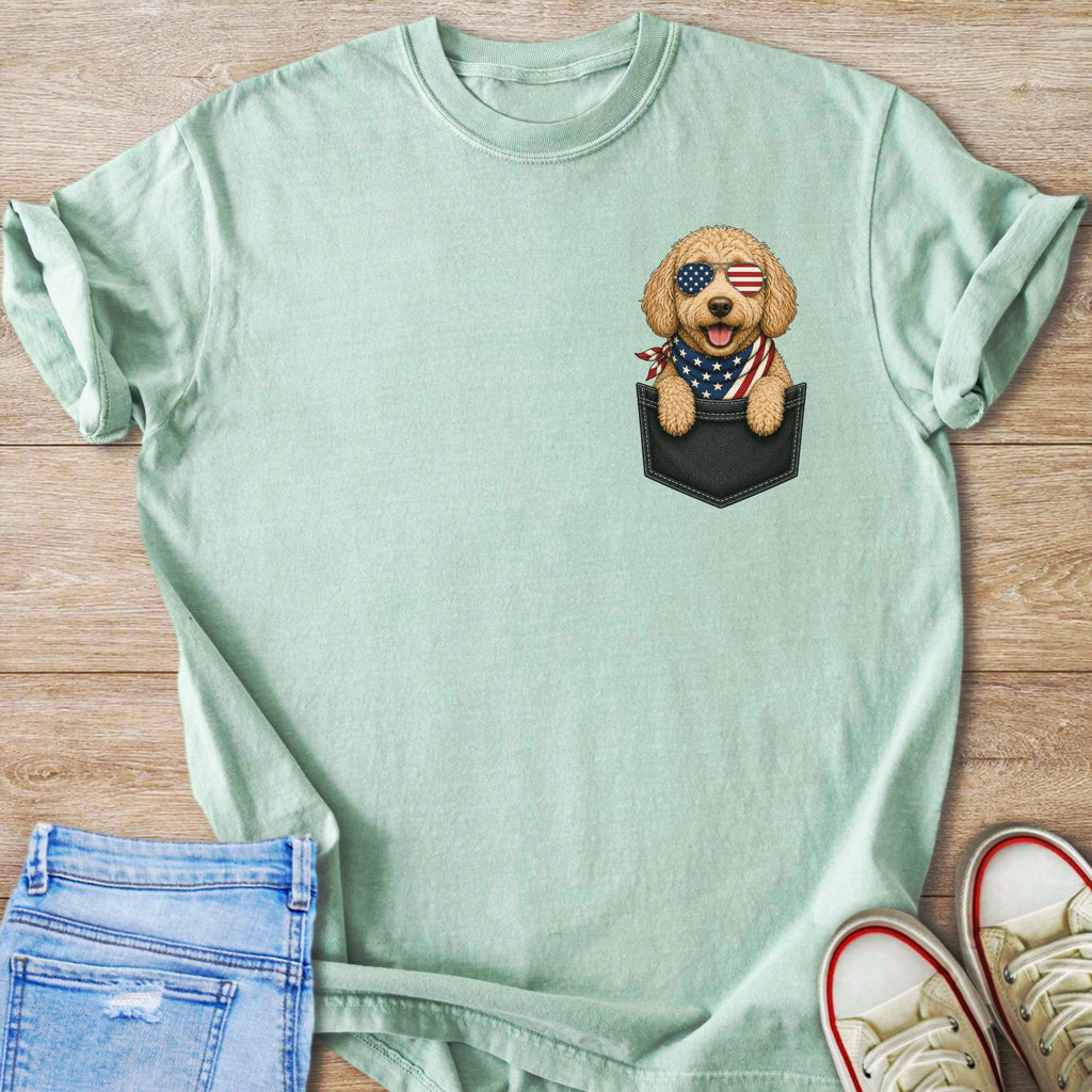 Mint t-shirt with a printed golden retriever wearing American flag sunglasses and bandana in a pocket.