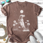 Dog sitting in grass with moon and daisies, t-shirt mockup.