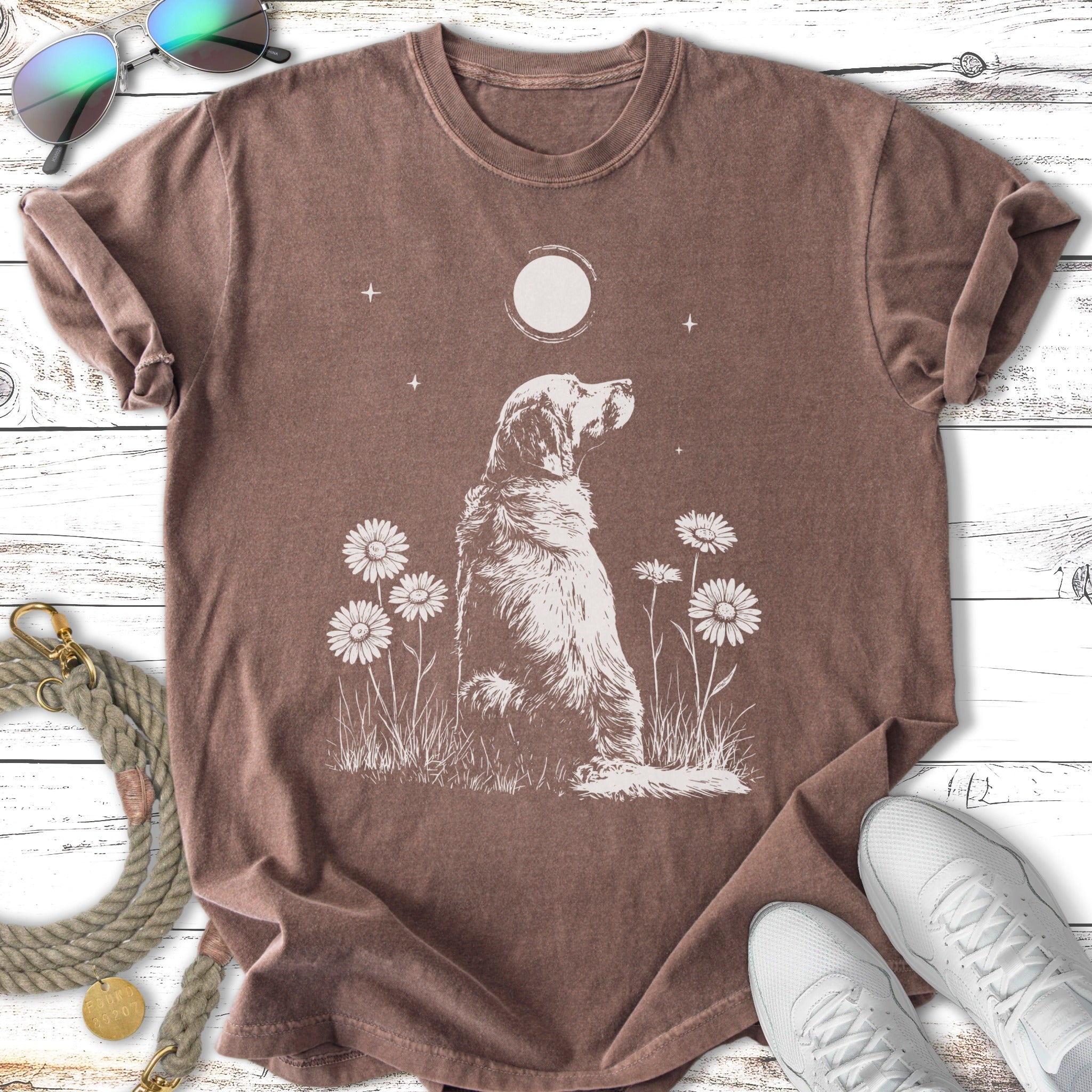 Dog sitting in grass with moon and daisies, t-shirt mockup.