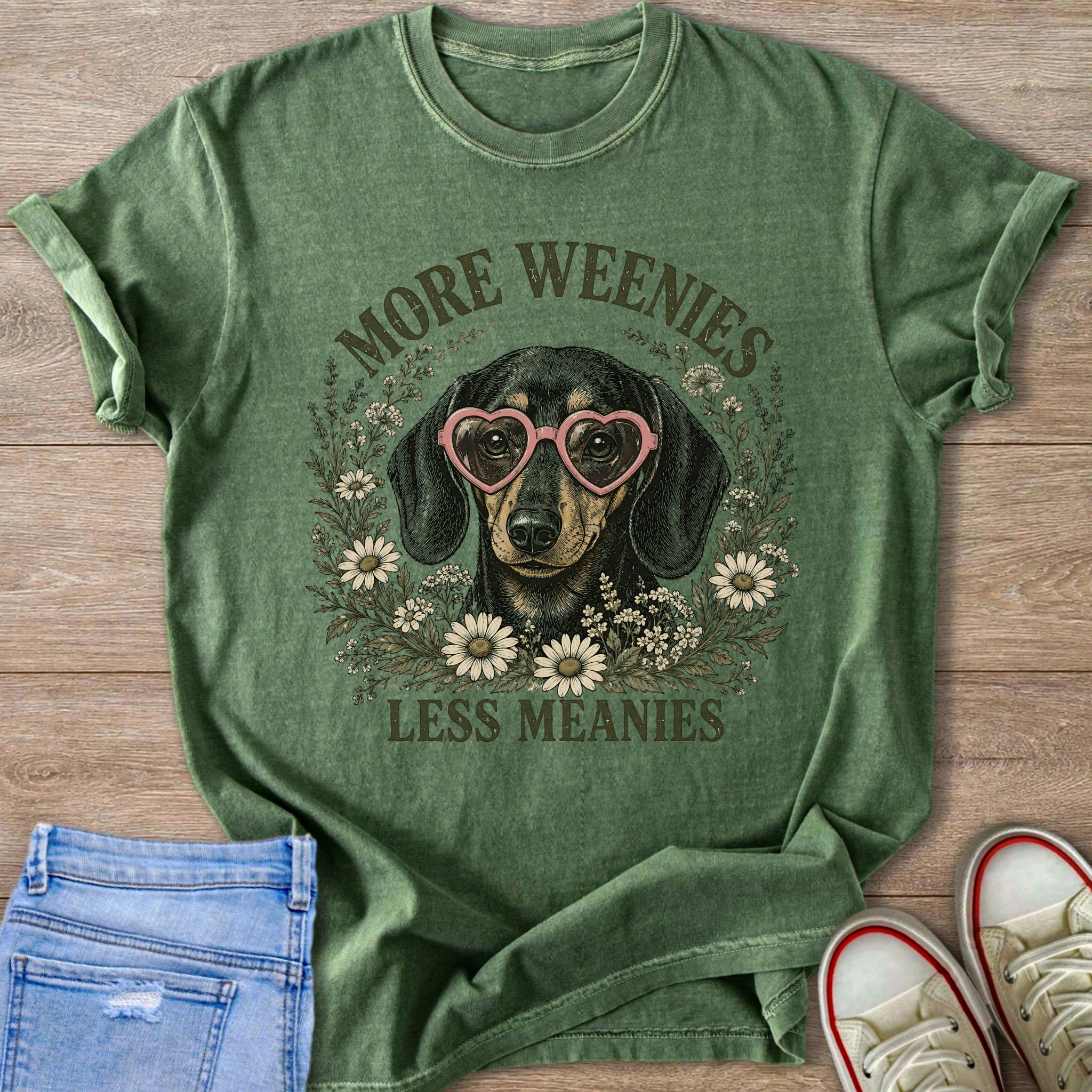 Green t-shirt with a dachshund wearing pink heart glasses and text.