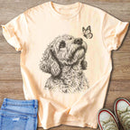 Peach t-shirt with a sketch of a dog looking up at a butterfly.