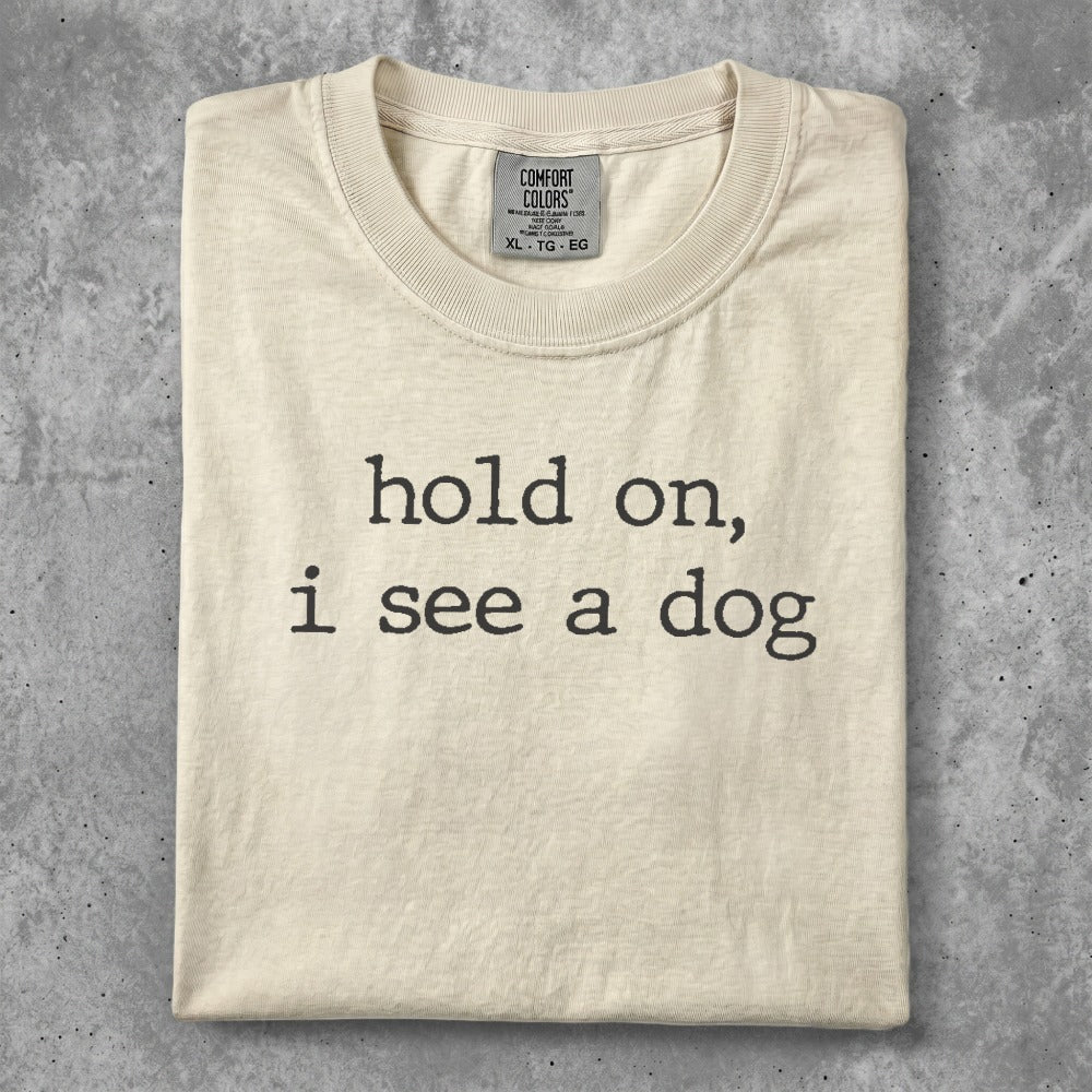 Cream t-shirt with "hold on, i see a dog" text.