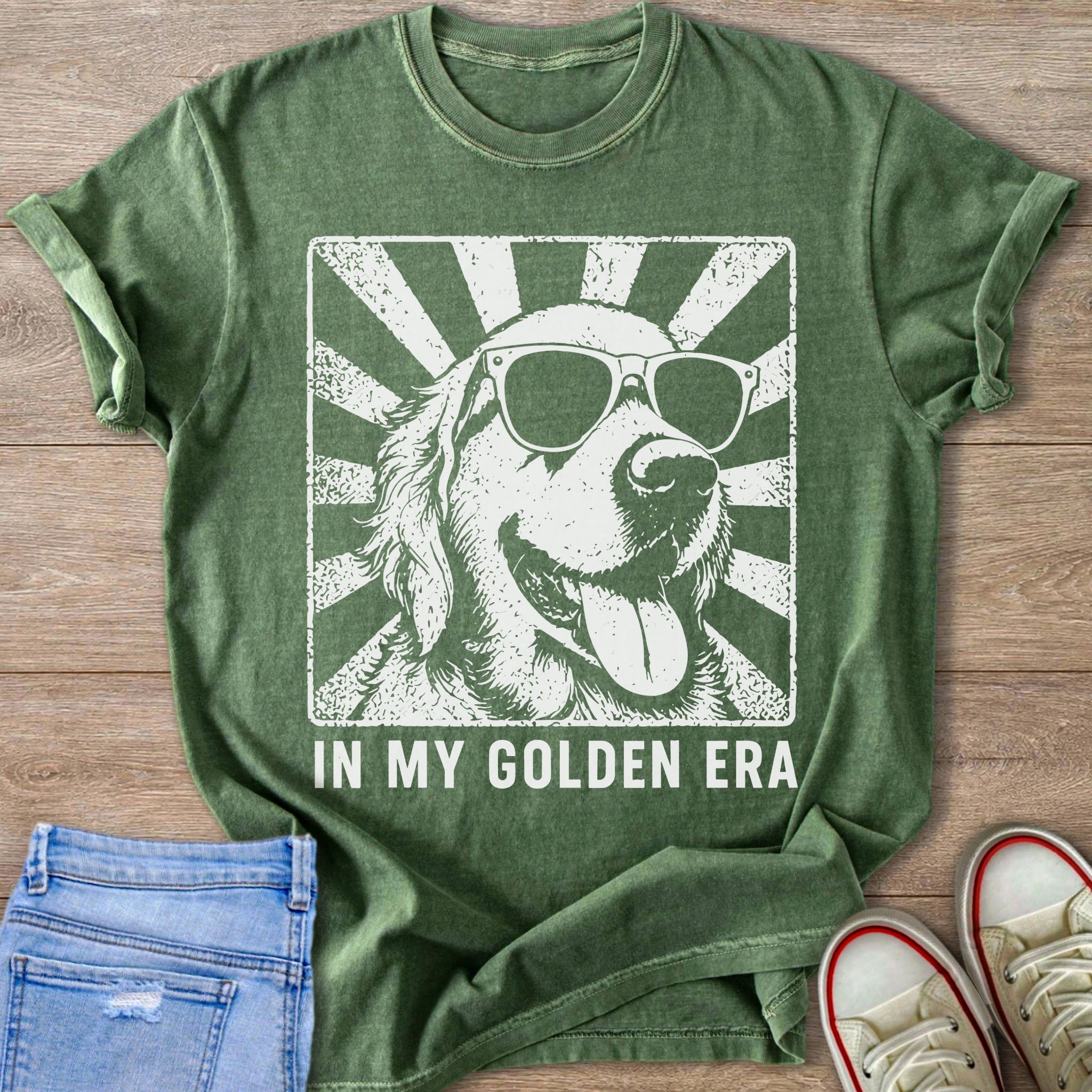 Green t-shirt with retro distressed graphic of a golden retriever wearing sunglasses and text "IN MY GOLDEN ERA."