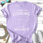Purple t-shirt with white text "I CAUGHT YOU LOOKING AT MY WEINER" and a dachshund.