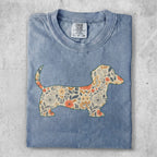 Blue t-shirt with a dachshund silhouette filled with floral patterns.