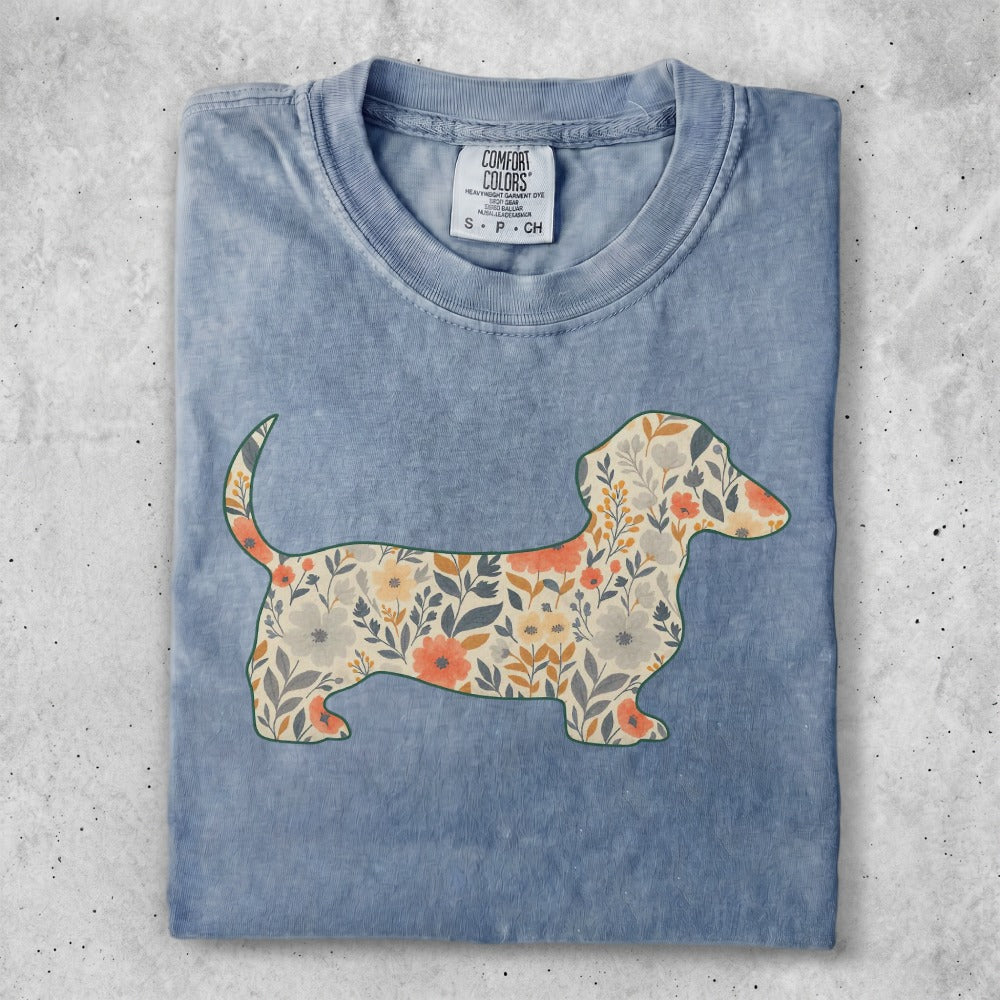Blue t-shirt with a dachshund silhouette filled with floral patterns.