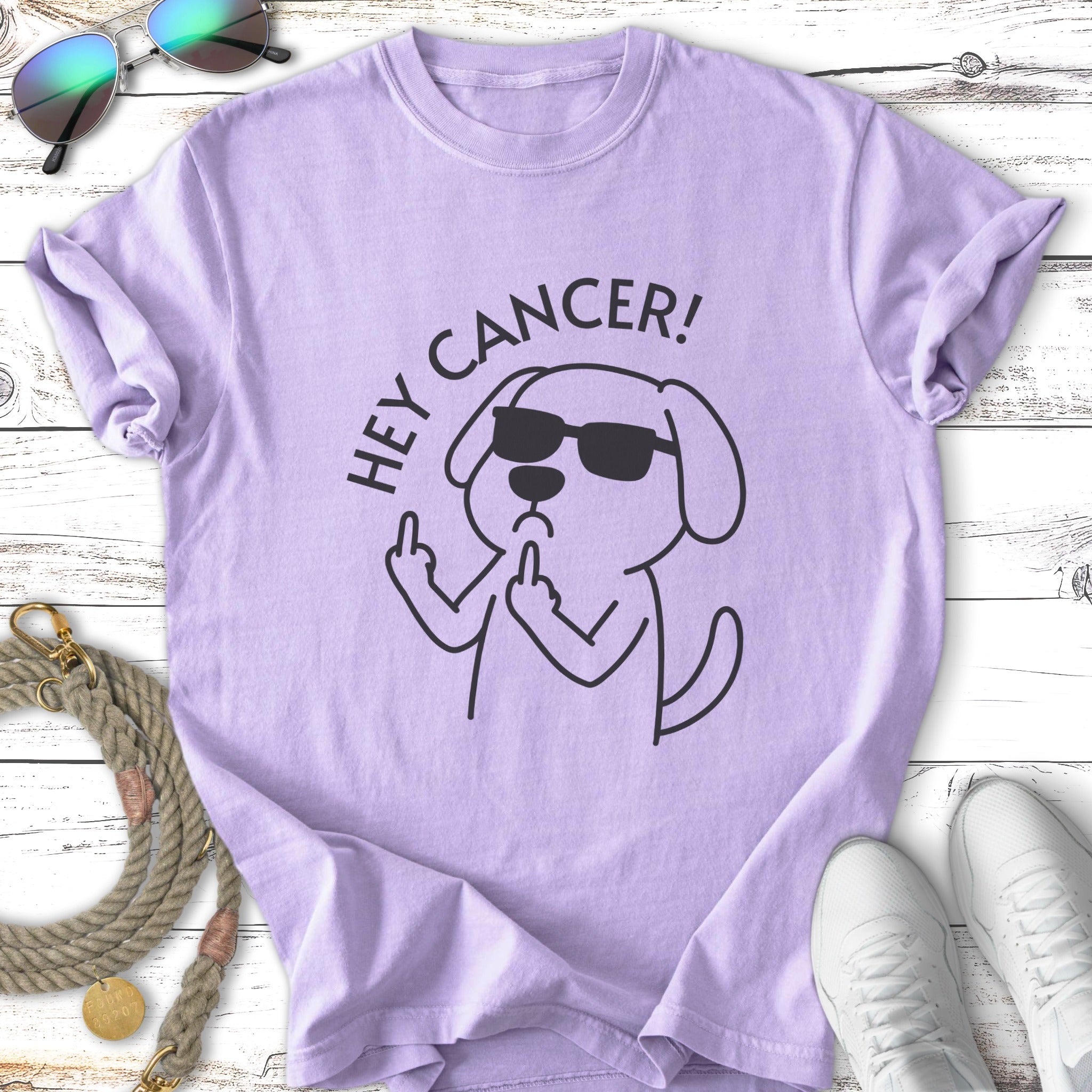 Lavender t-shirt with dog wearing sunglasses flipping middle finger, text "HEY CANCER!".