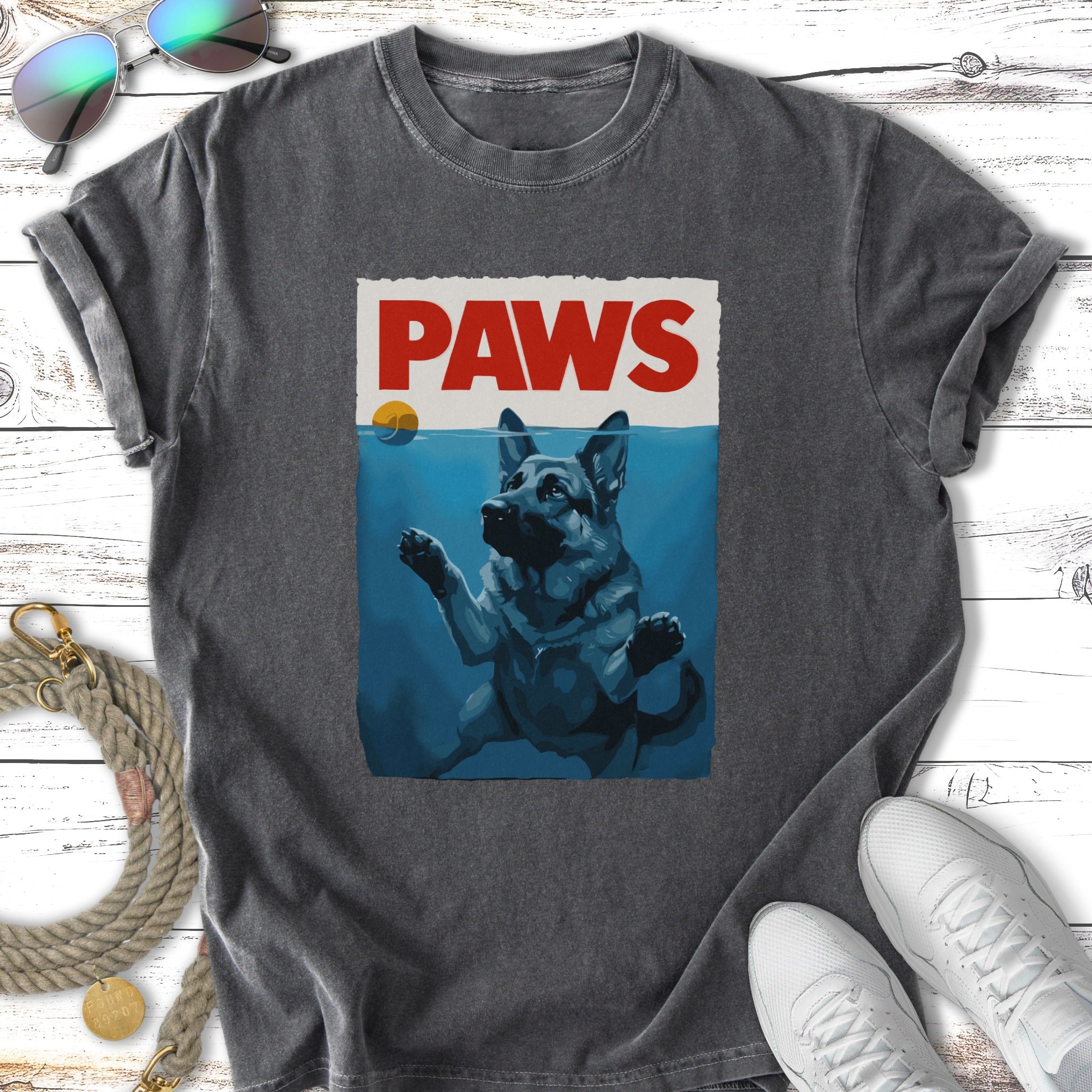German Shepherd reaching for a floating ball in water, "PAWS" text above.
