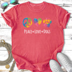Coral t-shirt with peace, heart, and paw print icons and "Peace Love Dogs" text.