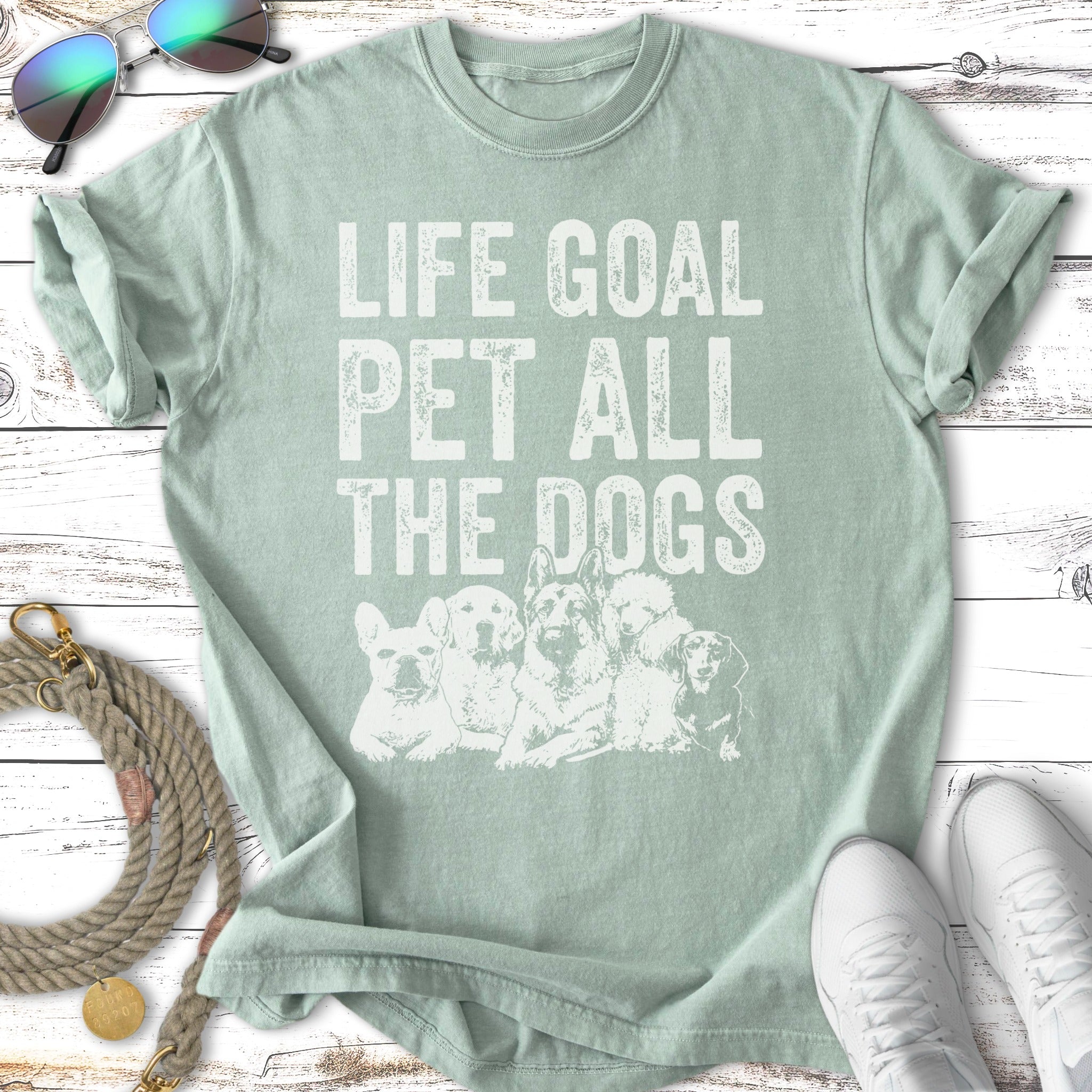 Green t-shirt with "Life Goal Pet All The Dogs" and dog silhouettes.