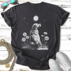 Graphic tee with white dog and daisies under moonlight.