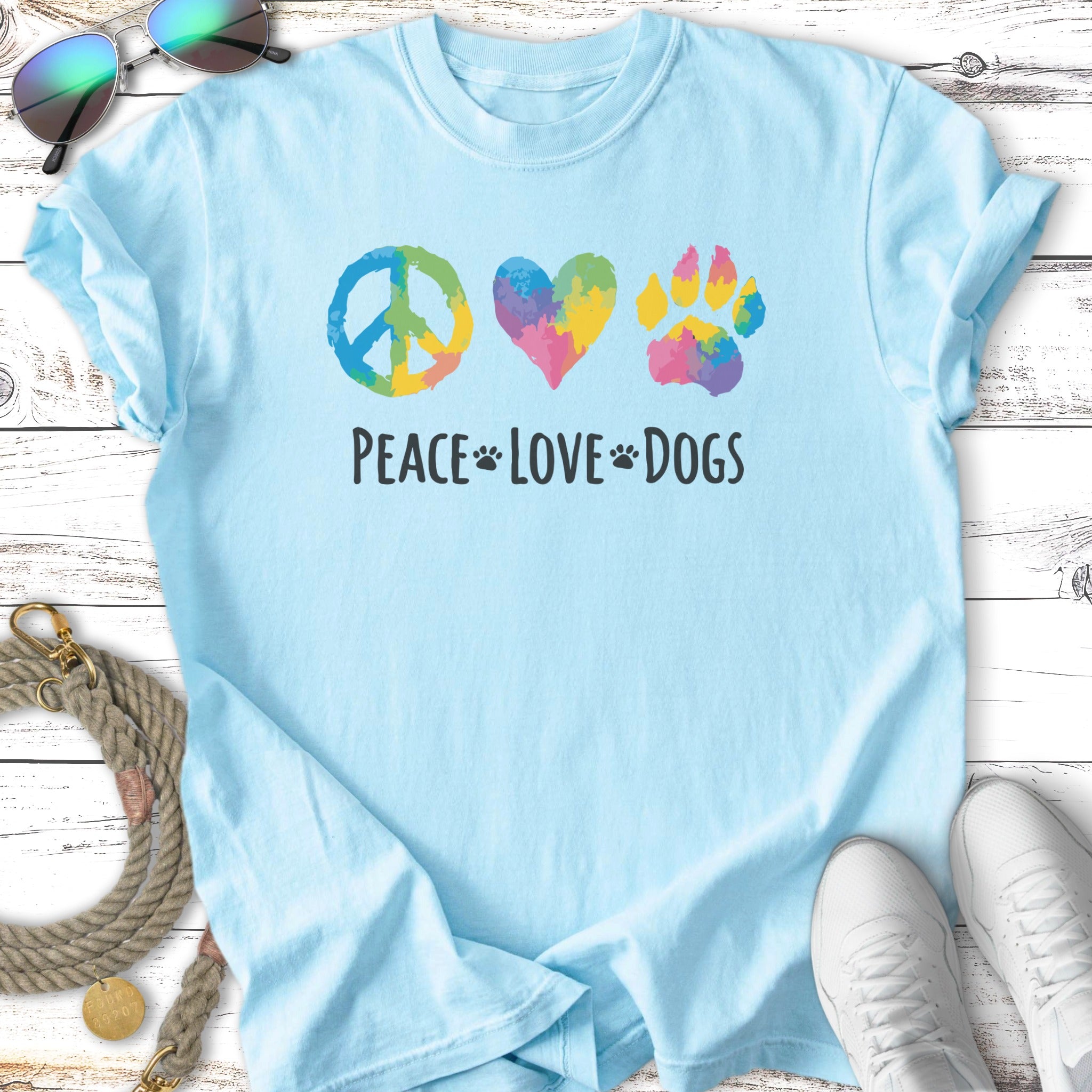Light blue t-shirt with peace sign, heart, and paw print; "Peace Love Dogs" text.