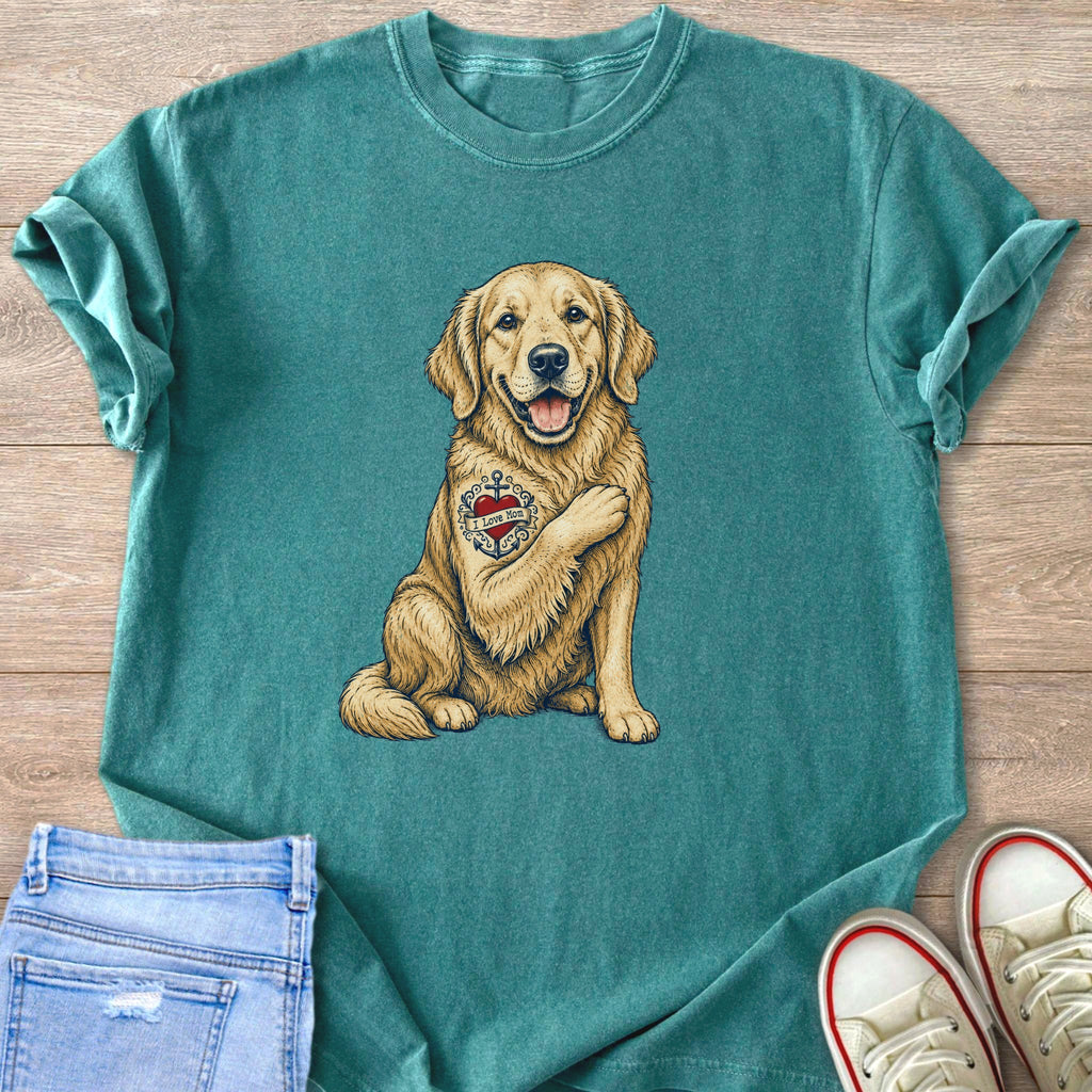 Golden Retriever with "I Love Mom" anchor tattoo on chest, seated.
