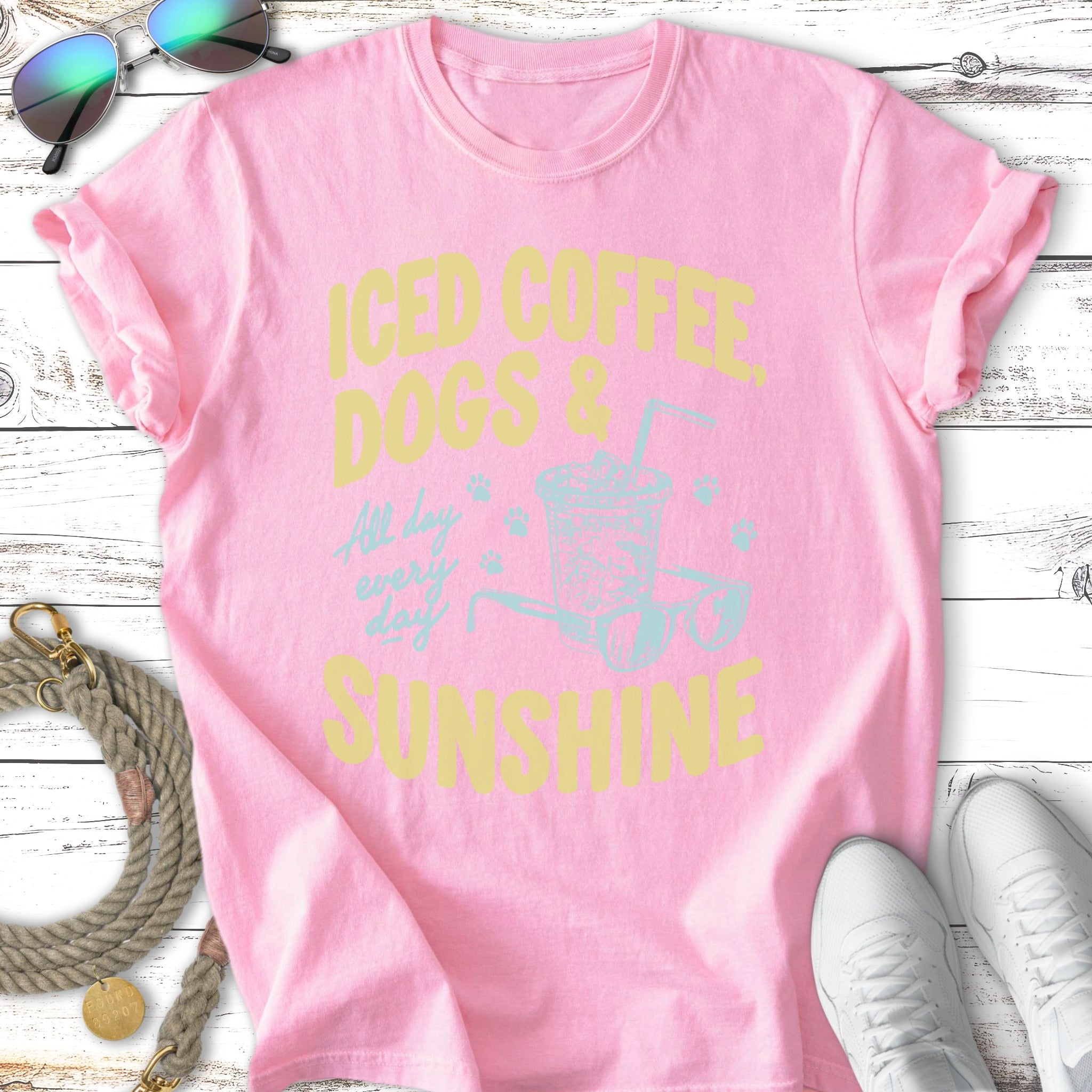 Pink t-shirt with "Iced Coffee Dogs & Sunshine" text and graphic.