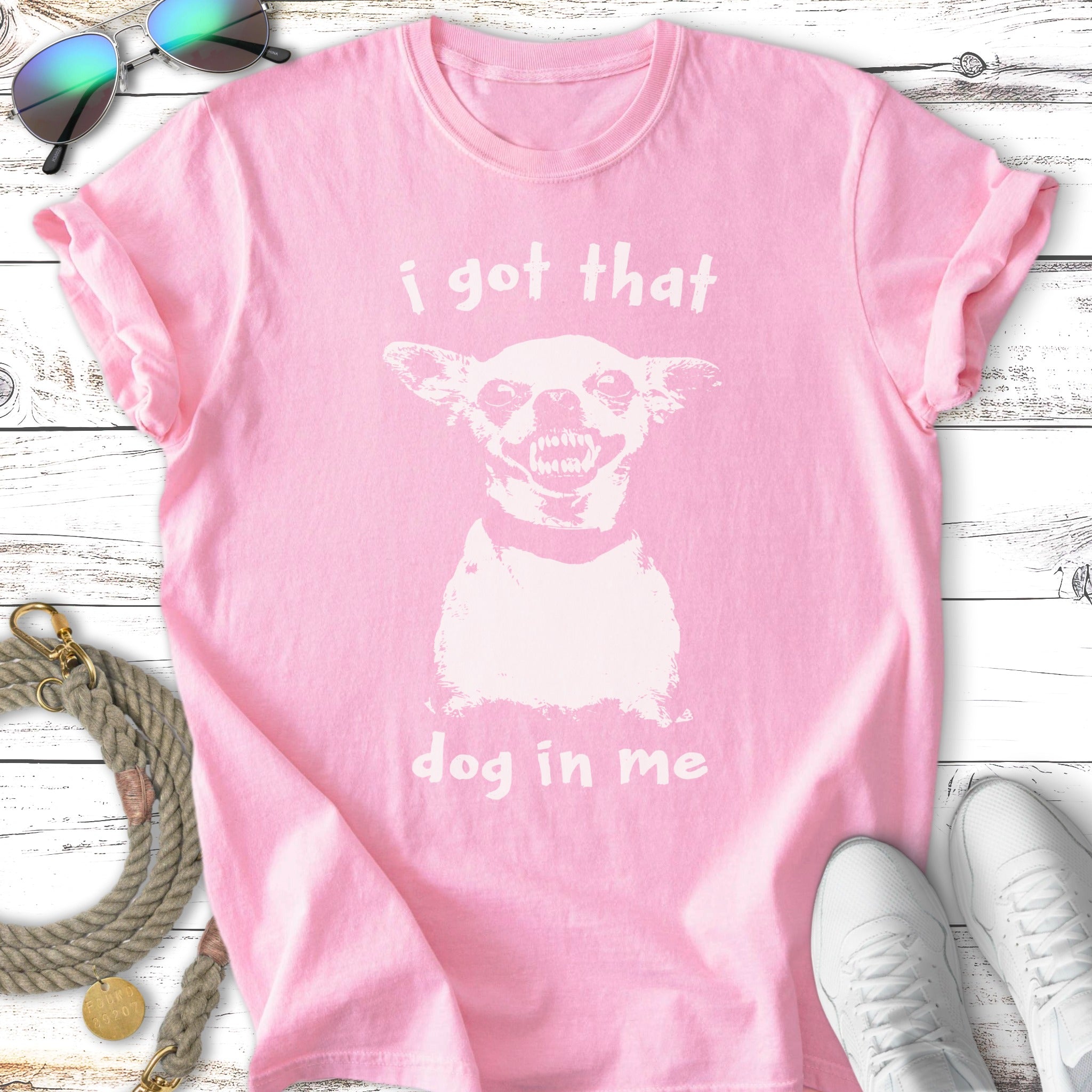 Pink t-shirt with "I got that dog in me" and dog graphic.
