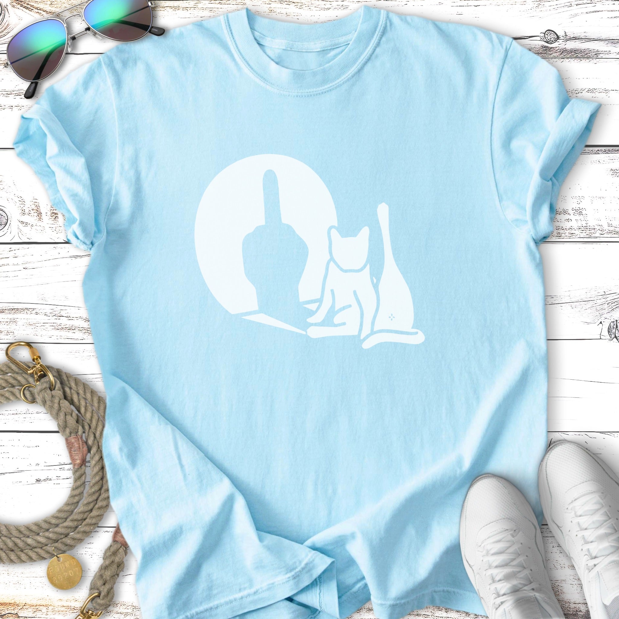Light blue t-shirt with white graphic of a cat sitting and a middle finger.