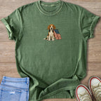 Green t-shirt with beagle holding American flag graphic with distressed denim and sneakers.
