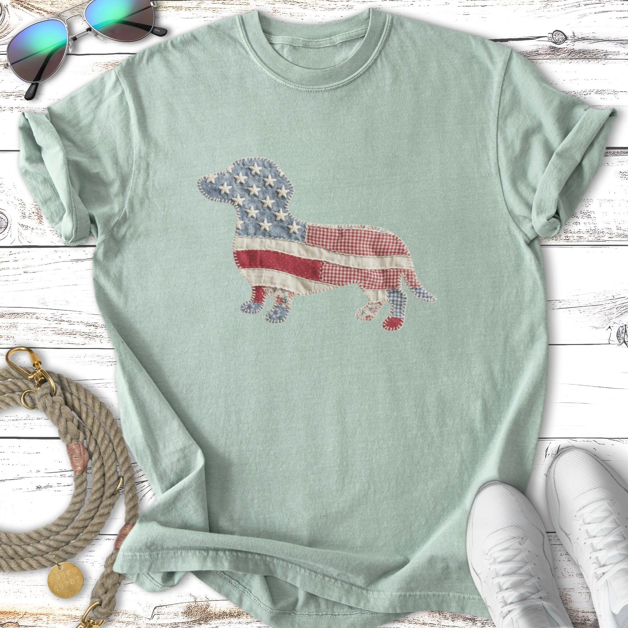 Light blue t-shirt with a dachshund silhouette made of American flag fabric.