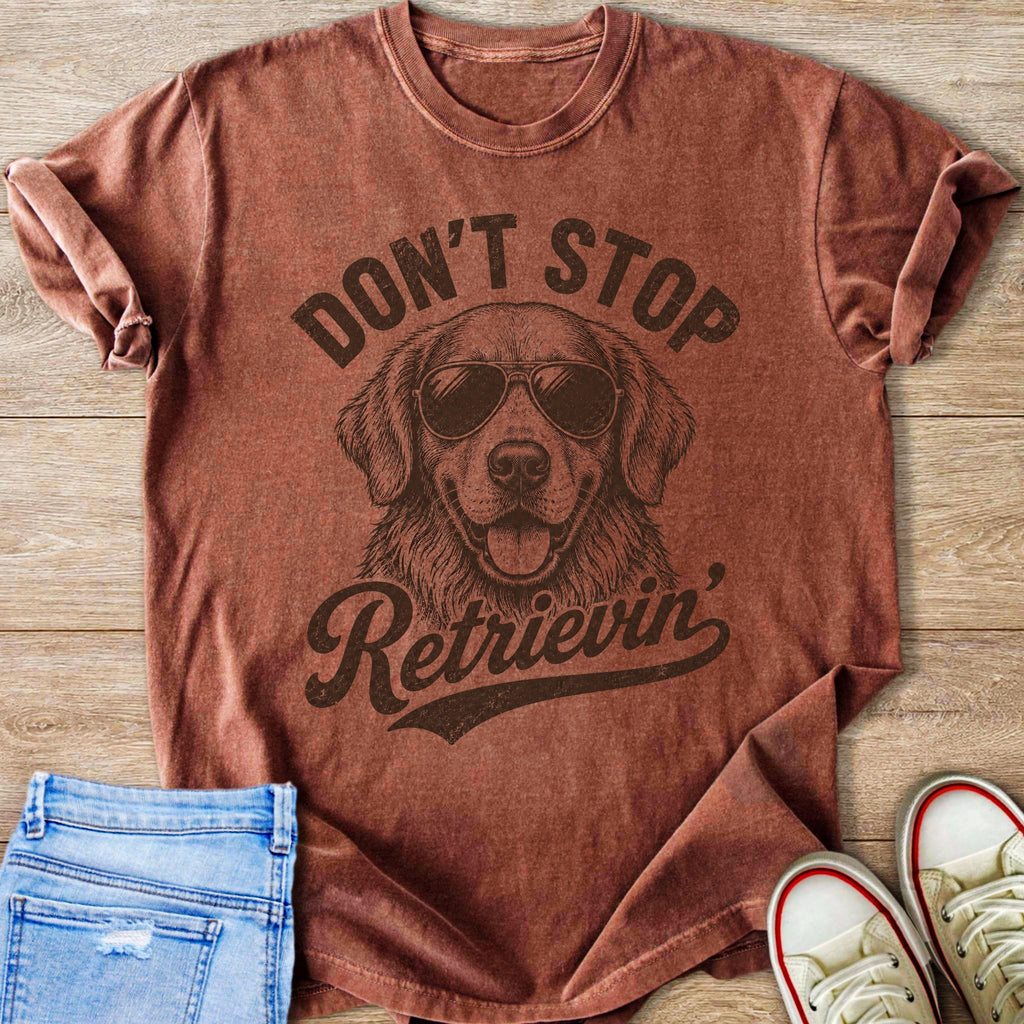 Brown t-shirt with a graphic of a golden retriever wearing sunglasses and the text "Don't Stop Retrieving".