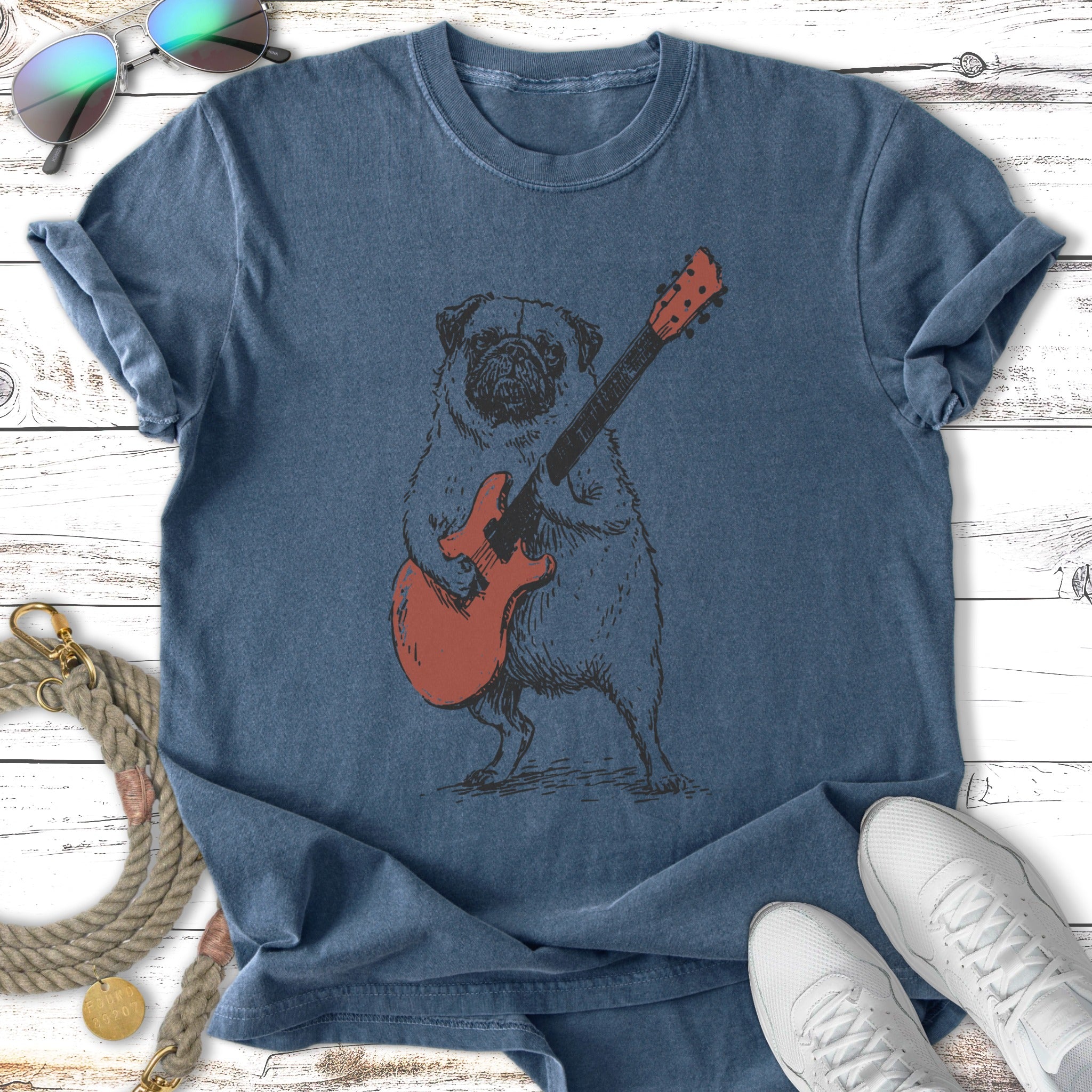 Pug playing a red electric guitar.