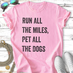 Pink t-shirt with "Run all the miles, pet all the dogs" text.
