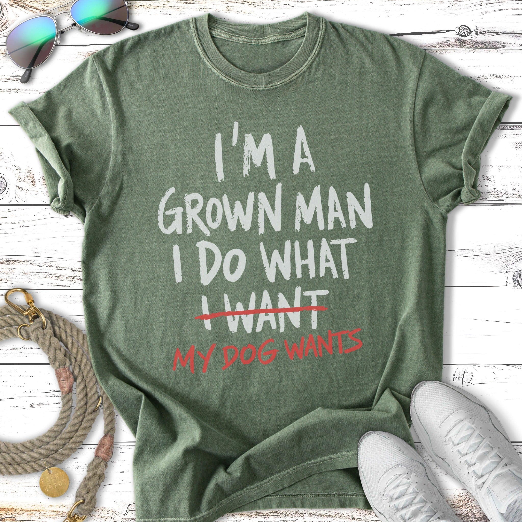 Green t-shirt with "I'm a grown man I do what I want my dog wants" text.