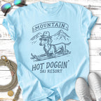 Light blue t-shirt with "HOT DOGGIN' SKI RESORT" and a dachshund on skis.
