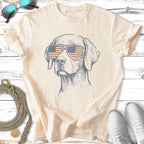 Line drawing of a dog wearing American flag sunglasses on a cream t-shirt.