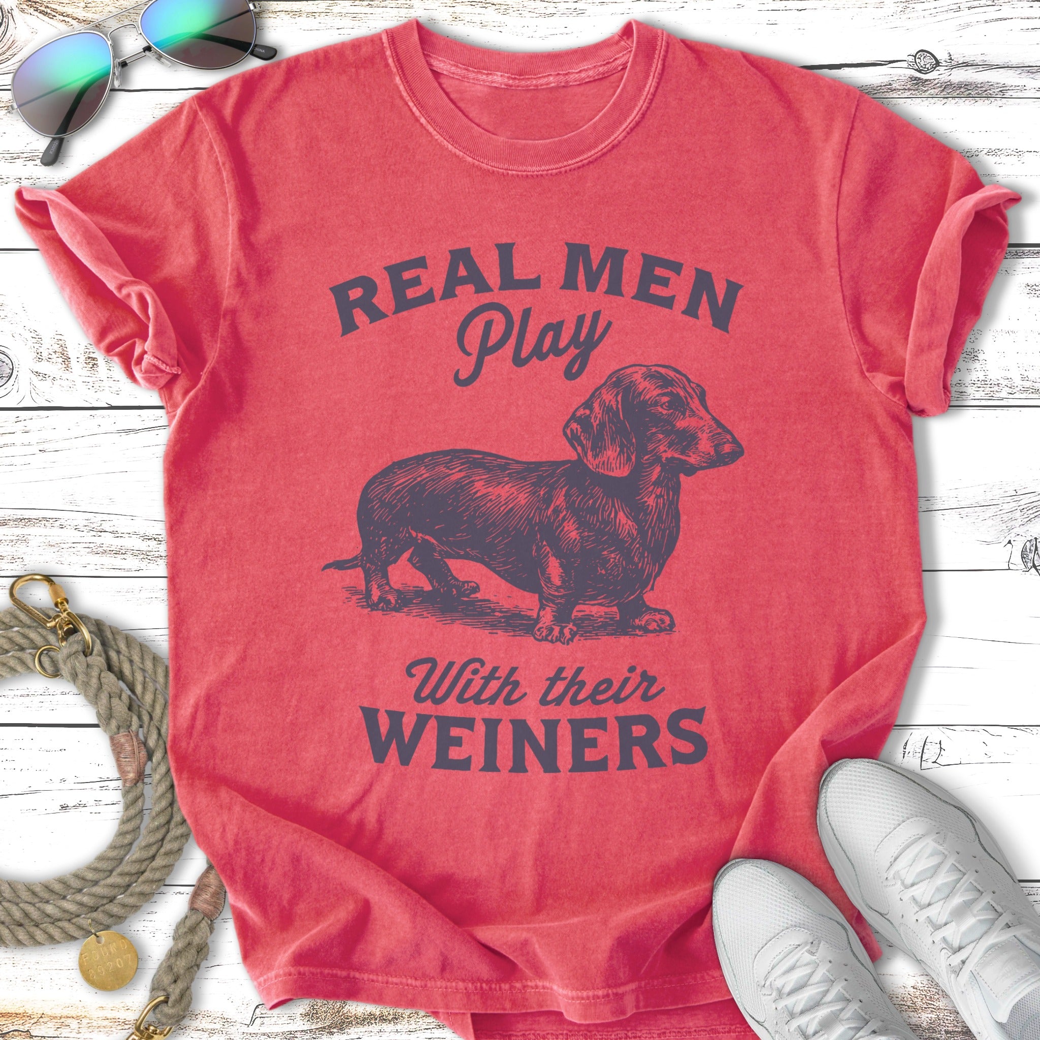 Red t-shirt with "Real Men Play With Their Weiners" and a dachshund graphic.