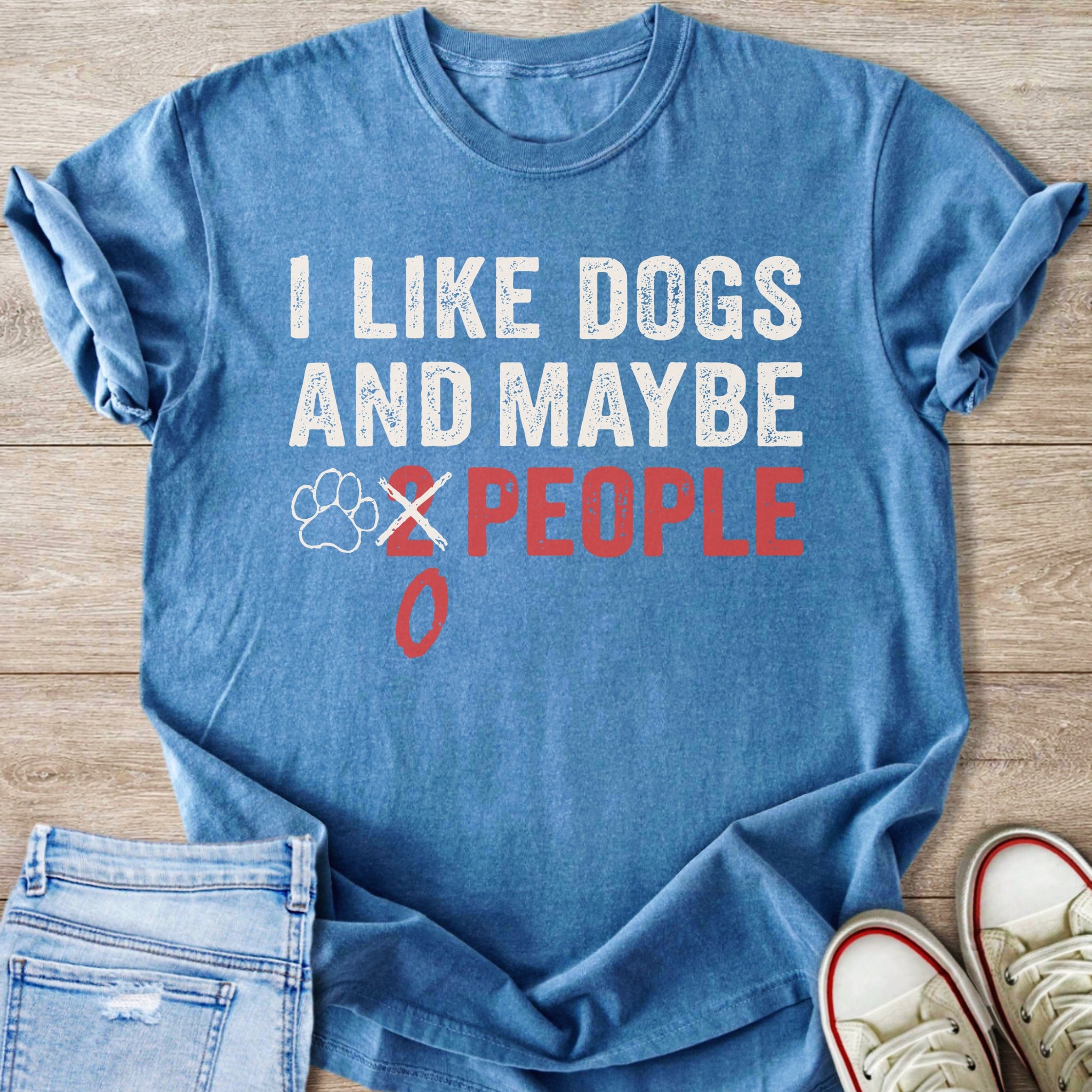 Blue t-shirt with white text reading "I LIKE DOGS AND MAYBE 2 PEOPLE" with a paw print.