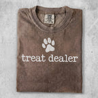 Comfort Colors brown t-shirt with "treat dealer" and paw print graphic.
