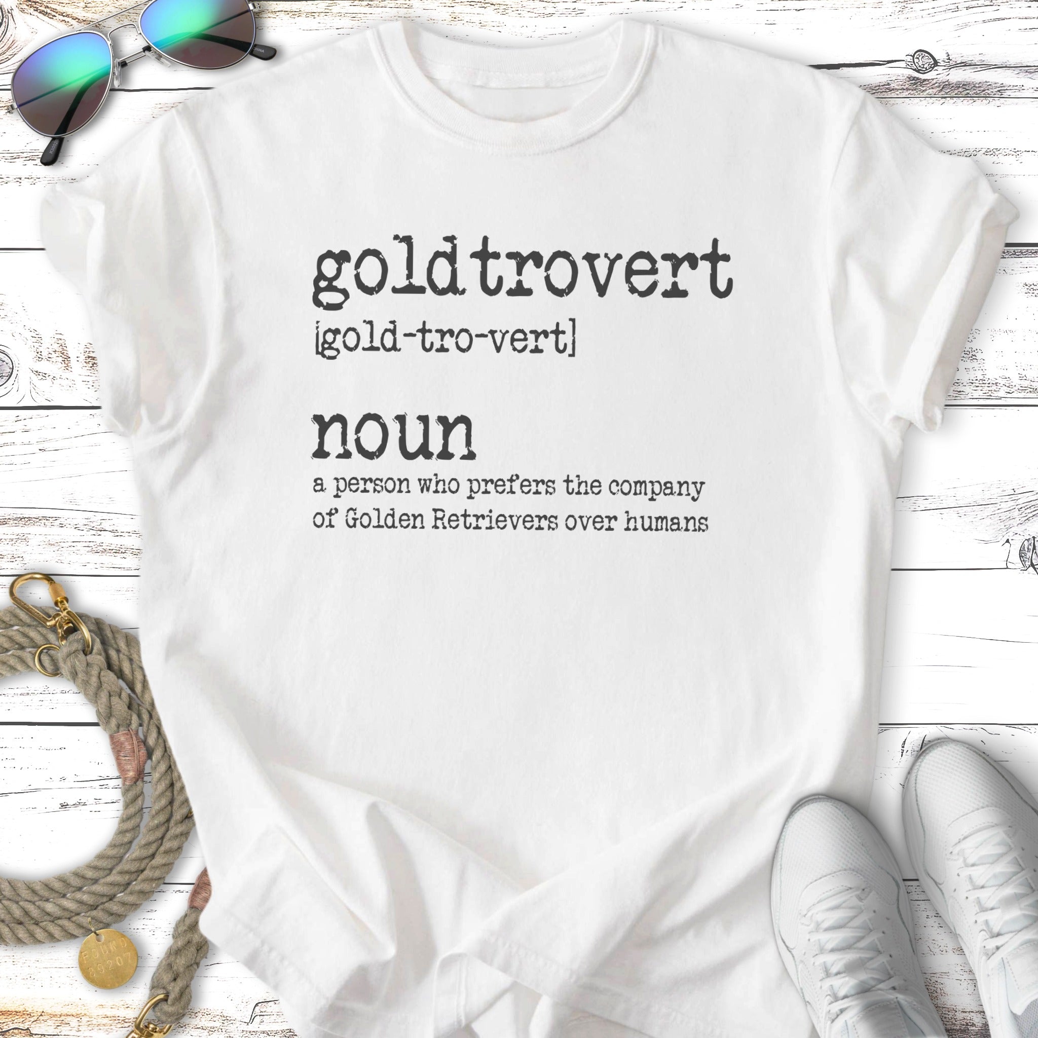 White t-shirt with "goldtrovert" definition and graphic elements.