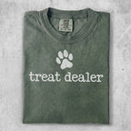 Green t-shirt with "treat dealer" text and paw print graphic.
