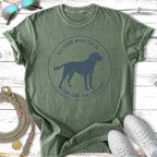 Green t-shirt with a blue graphic of a dog in a circle and text.