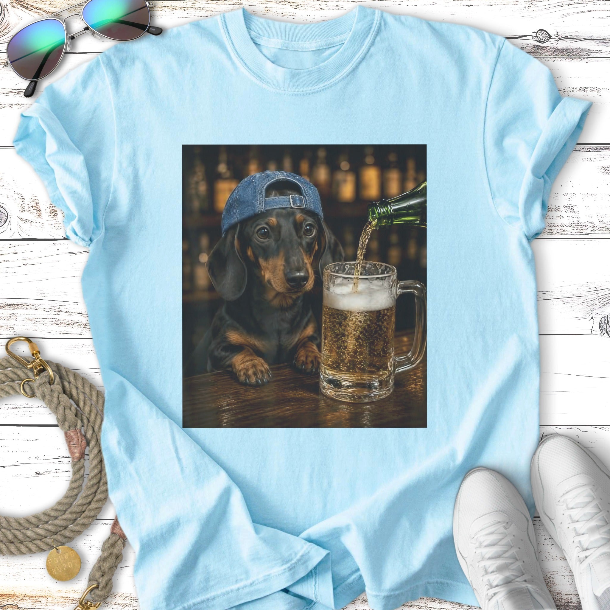 Dachshund wearing a blue baseball cap pours beer into a glass.