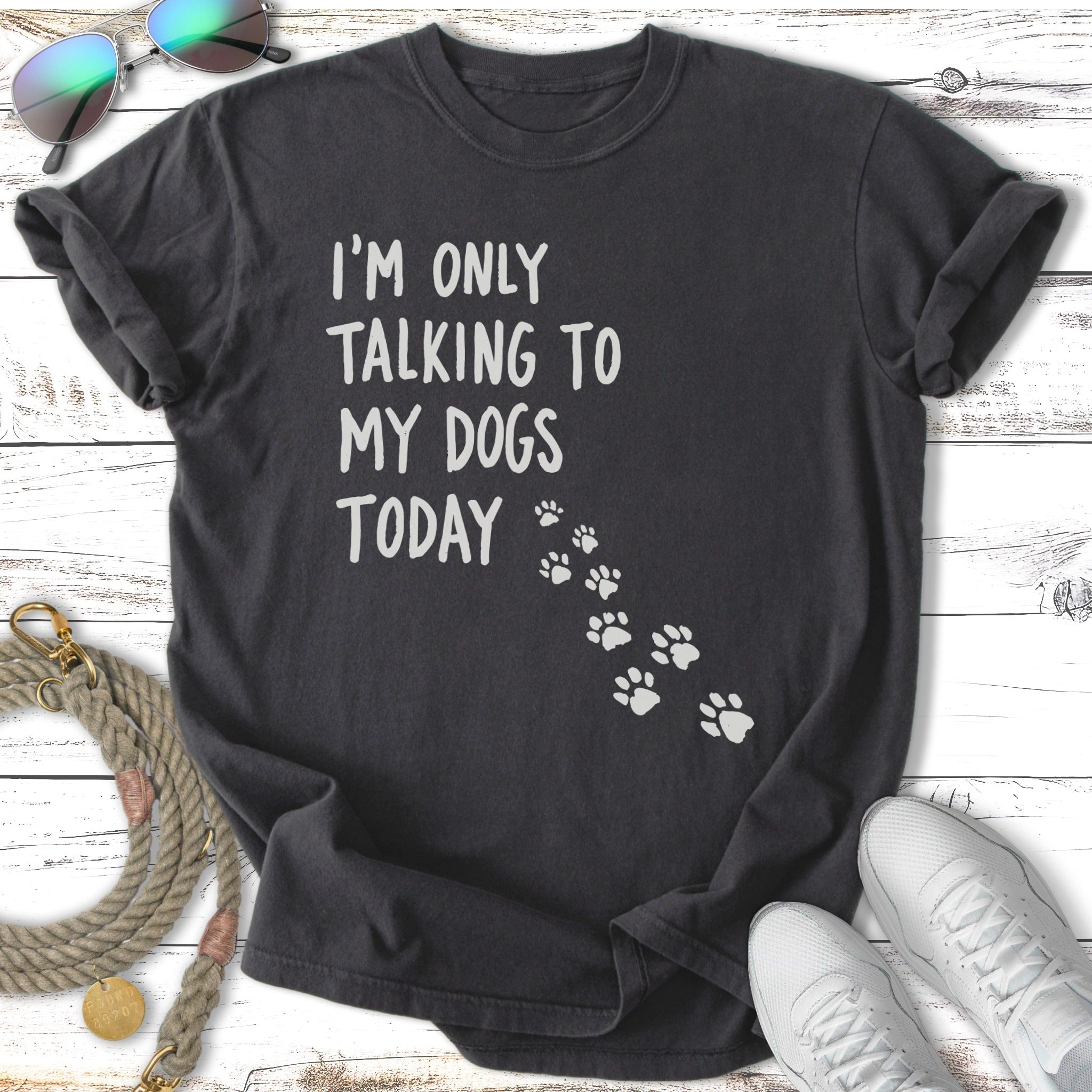 Dark t-shirt with white text "I'm only talking to my dogs today" and paw prints.
