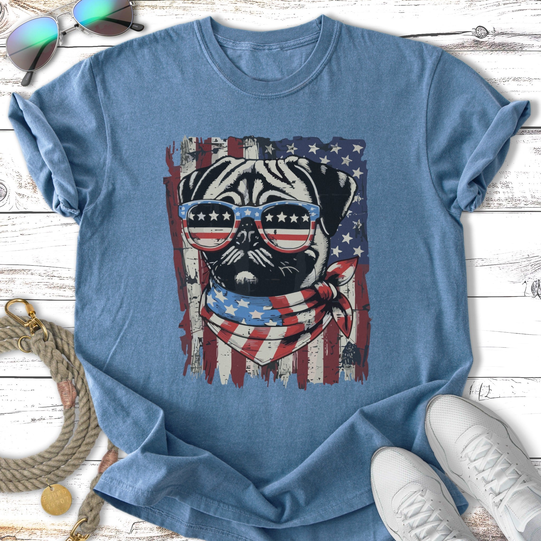 Pug wearing sunglasses and bandana with American flag print.