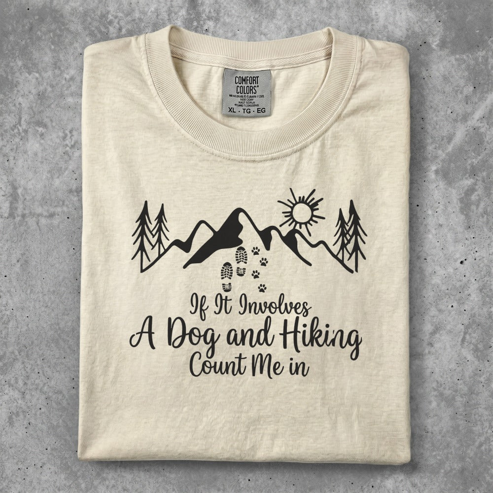 Cream t-shirt with "If It Involves A Dog and Hiking Count Me In" and mountain graphic.