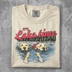Two golden retrievers swimming in a lake, "It's Lake time" text above.