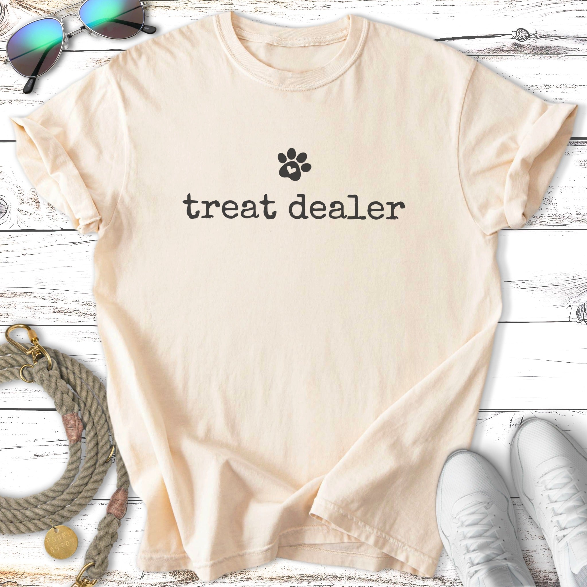Cream t-shirt with black paw print and "treat dealer" text.